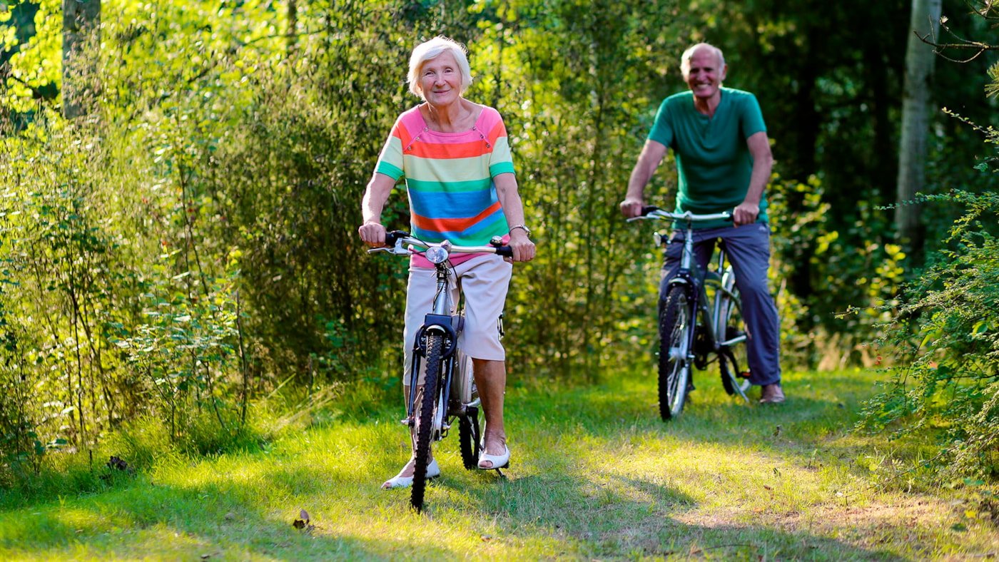 Mann og dame på sykkeltur i skogen